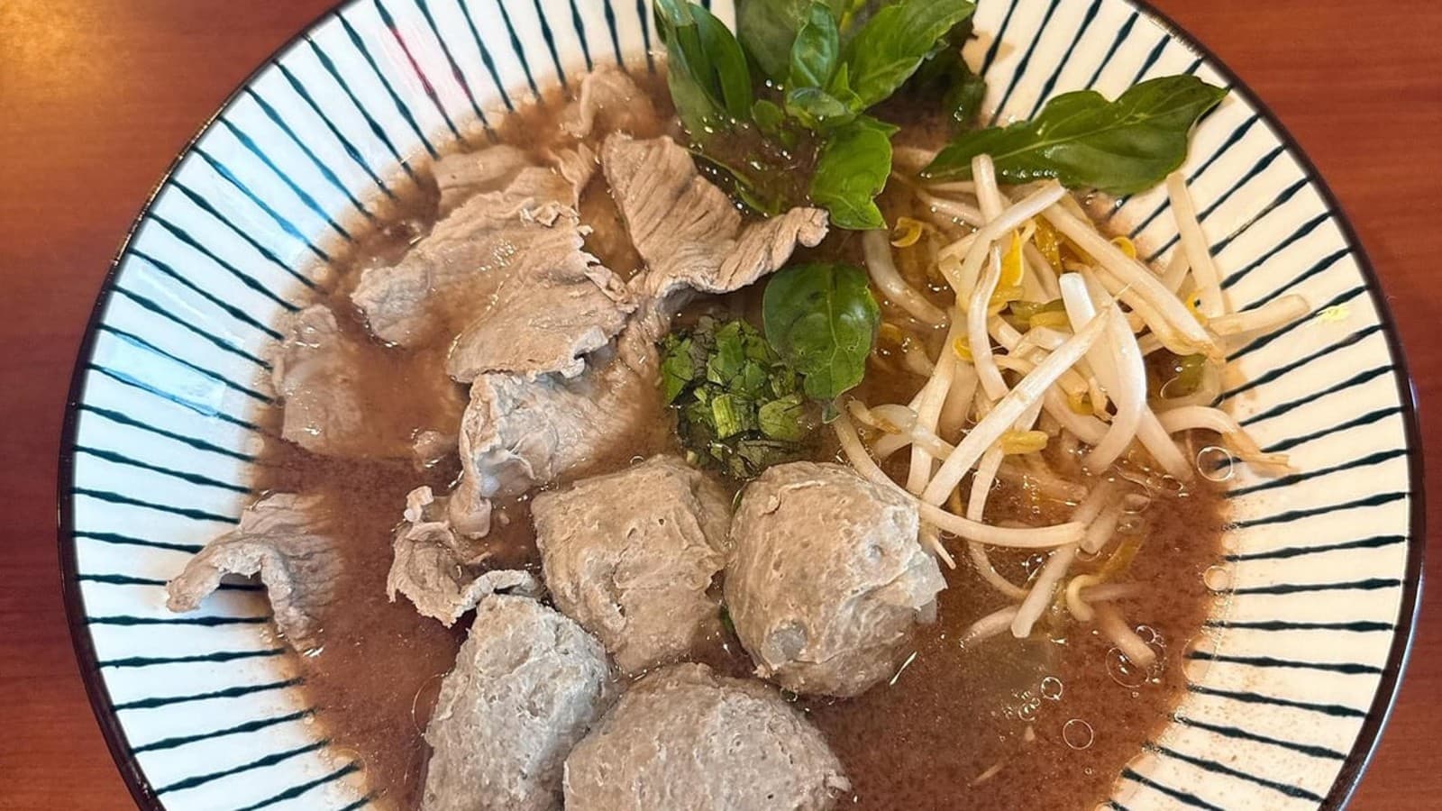 The dining room inside Senlek Thai Rice & Noodles with vivid blue walls.